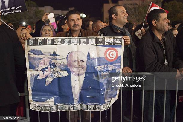 Supporters of Tunisian Nidaa Tounes Party's chief and presidential candidate Beji Caid Essebsi celebrate after the first results following the second...