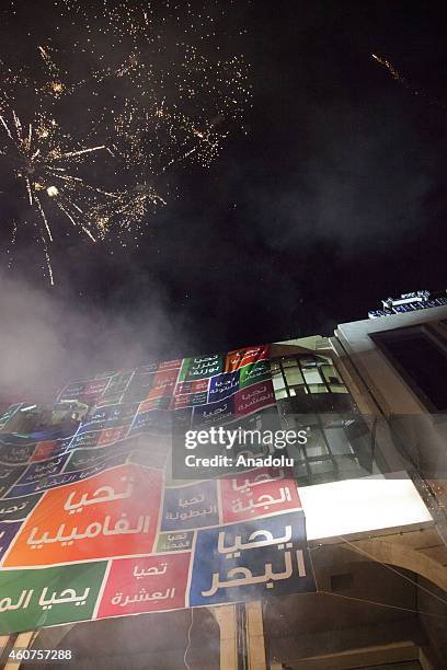 Supporters of Tunisian Nidaa Tounes Party's chief and presidential candidate Beji Caid Essebsi celebrate after the first results following the second...