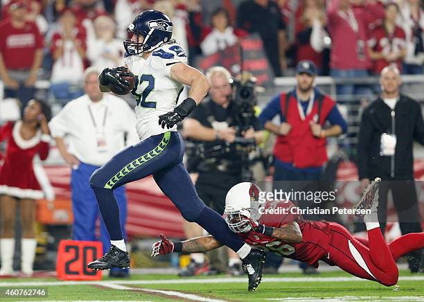 Tight end Luke Willson of the Seattle Seahawks runs the football against free safety Rashad Johnson of the Arizona Cardinals to score a 80 yard...
