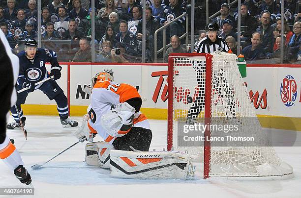 Blake Wheeler of the Winnipeg Jets watches as the puck flies into the net behind goaltender Rob Zepp of the Philadelphia Flyers on a shot by Dustin...