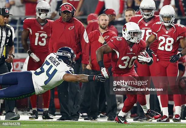 Running back Stepfan Taylor of the Arizona Cardinals runs with the football after a reception past middle linebacker Bobby Wagner of the Seattle...