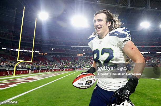 Tight end Luke Willson of the Seattle Seahawks runs off the field with the "sunday night football player of the game ball" after defeating the...