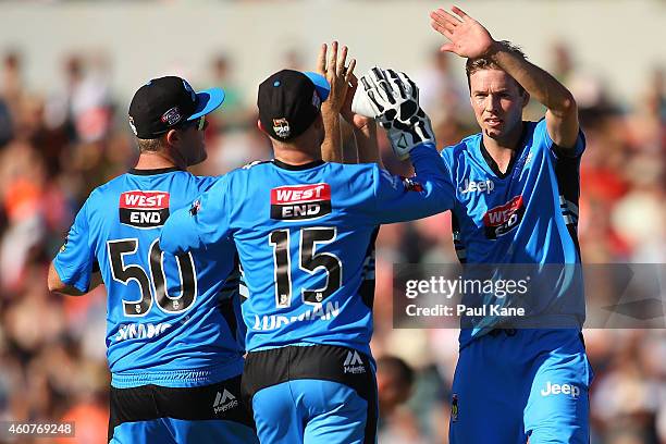 Ben Laughlin of the Strikers celebrates with Craig Simmons and Tim Ludeman after the wicket of Michael Carberry of the Scorchers during the Big Bash...