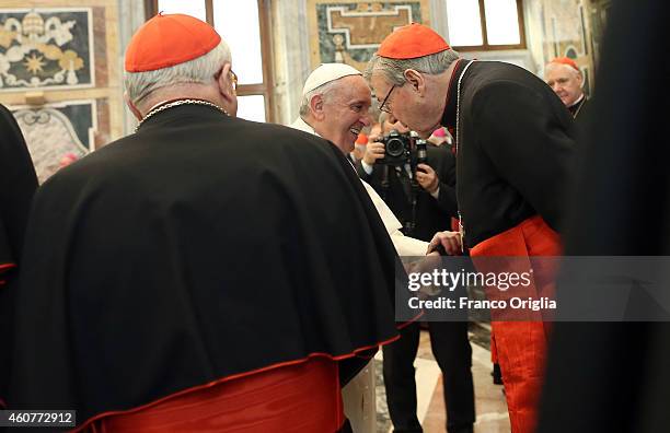 Pope Francis exchanges Christmas greetings with former Archbishop of Sydney, Cardinal George Pell at the Clementina Hall on December 22, 2014 in...