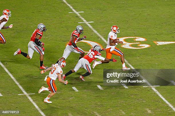 Tajh Boyd of the Clemson Tigers splits the defense of Tyvis Powell and Armani Reeves of the Ohio State Buckeyes to score a first quarter touchdown...