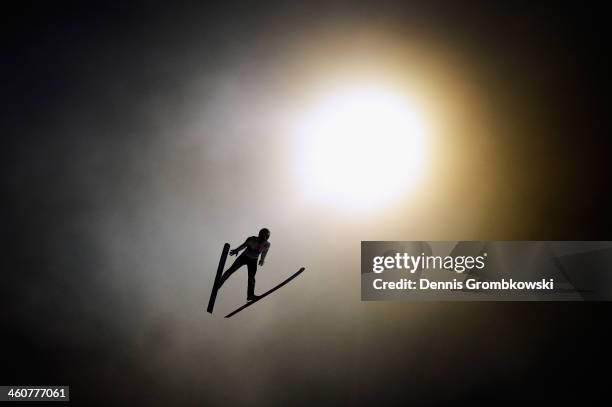 Thomas Diethart of Austria soars through the air during his qualification jump on day 1 of the 62nd Four Hills Tournament event at...