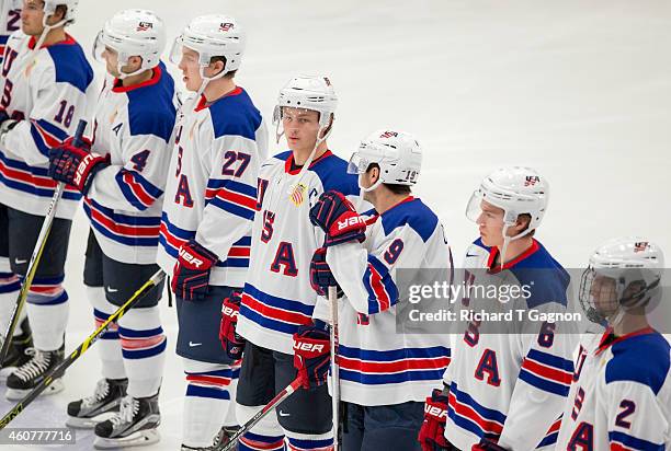 Jack Eichel of the USA National Junior Team stands on the blue line with teammates Will Butcher, Adam Erne, Cole Cassels and Ryan Collins prior to...