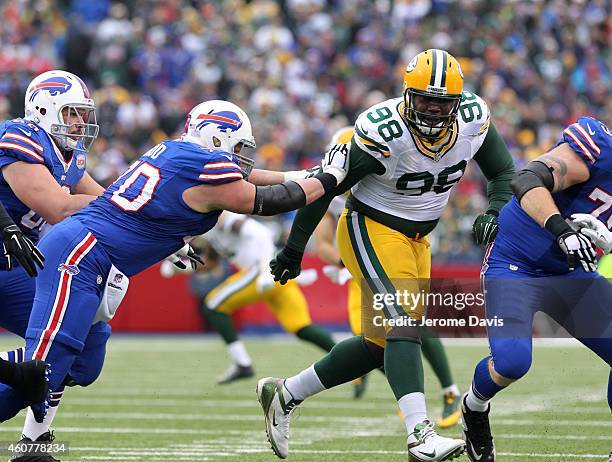 Eric Wood of the Buffalo Bills blocks Letroy Guion of the Green Bay Packers against the Green Bay Packers during the first half at Ralph Wilson...