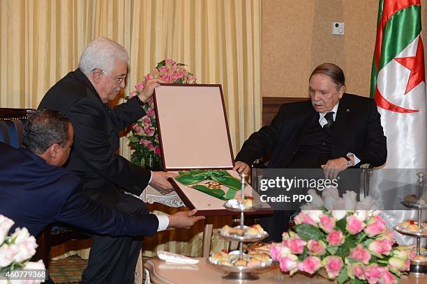 In this handout photo provided by the Palestinian Press Office , Palestinian President, Mahmoud Abbas during a meeting with Algerian President,...