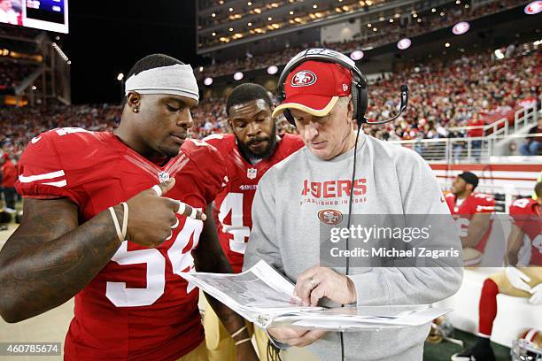 Linebackers Coach Jim Leavitt of the San Francisco 49ers talks with Nick Moody and Desmond Bishop during the game against the San Diego Chargers at...