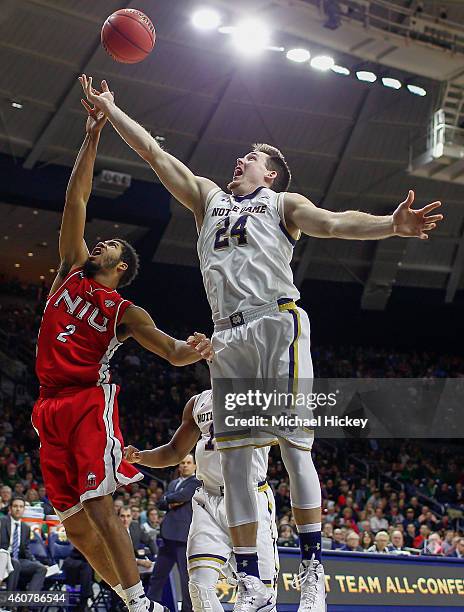 Aaron Armstead of the Northern Illinois Huskies and Pat Connaughton of the Notre Dame Fighting Irish battle for a rebound at Purcell Pavilion on...