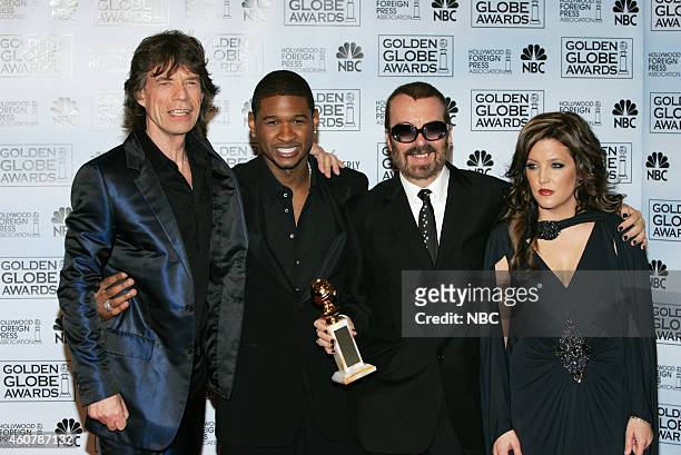 Pictured: Mick Jagger and David A. Stewart, winners of the award for Best Original Song for 'Old Habits Die Hard', pose in the press room with Usher...