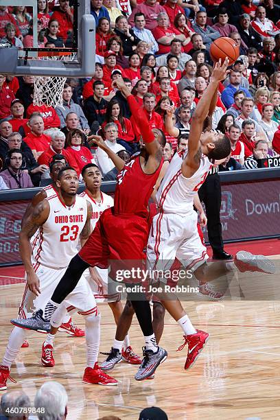 Marc Loving of the Ohio State Buckeyes rebounds over Chris Bryant of the Miami Redhawks during the game at Value City Arena on December 22, 2014 in...