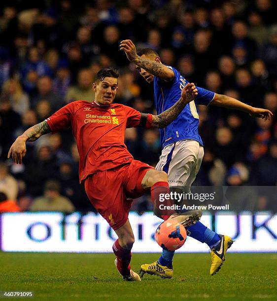 Daniel Agger of Liverpool and Jonson Clarke-Harris of Oldham Athletic compete during the Budweiser FA Cup Third Round match between Liverpool and...