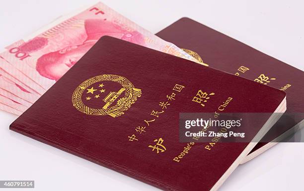 Renminbi banknotes and Chinese passports are arranged for photograph. Amid a strong U.S. Dollar and slower economic growth, China has seen its...