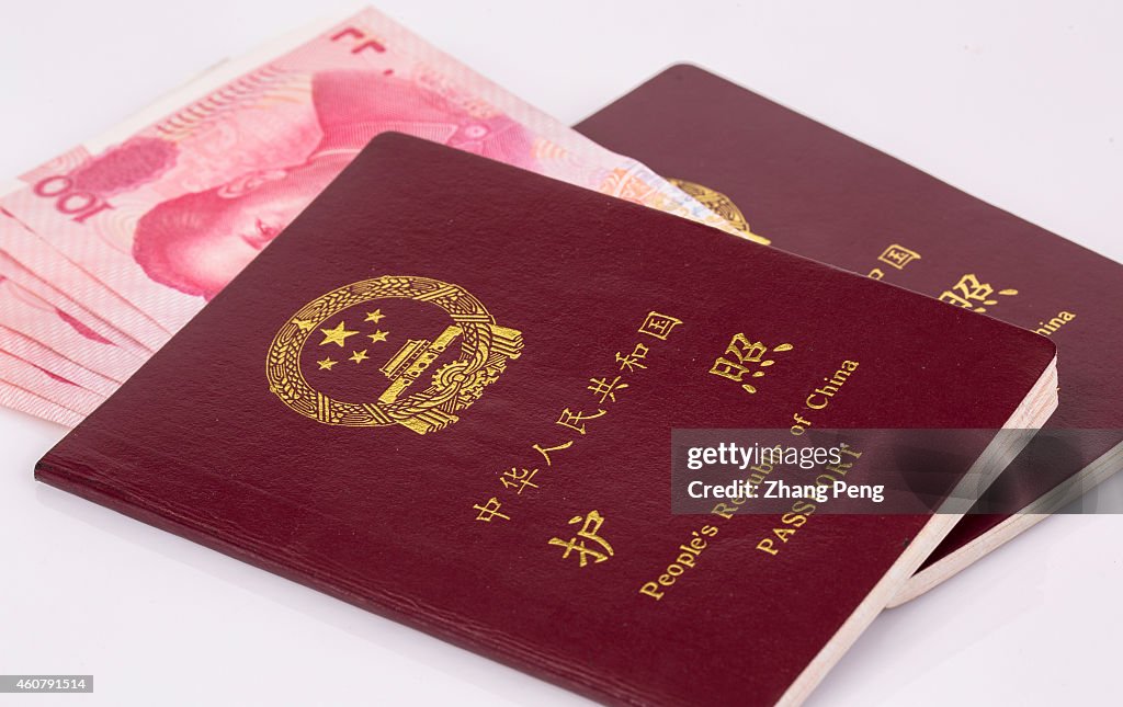 Renminbi banknotes and Chinese passports are arranged for...