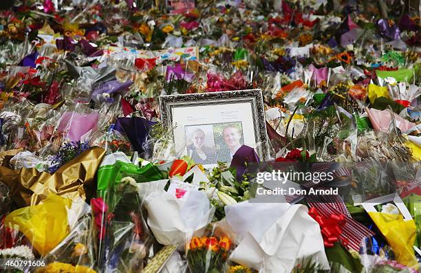 Photo tribute to Tori Johnson and Katrina Dawson is seen amongst the flowers at Martin Place on December 23, 2014 in Sydney, Australia. Volunteers...
