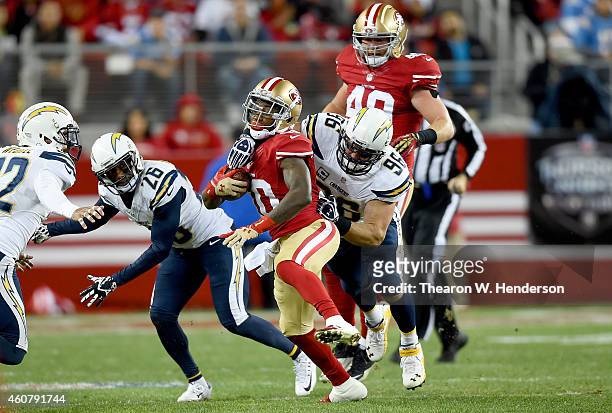 Bruce Ellington of the San Francisco 49ers gets tackled by Jarret Johnson of the San Diego Chargers at Levi's Stadium on December 20, 2014 in Santa...