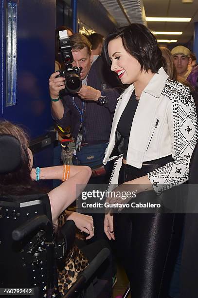 Demi Lovato visits with fan, Misty Short, during 93.3 FLZs Jingle Ball 2014 at Amalie Arena on December 22, 2014 in Tampa, Florida.