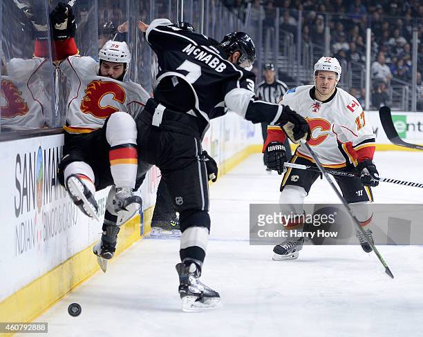 Brayden McNabb of the Los Angeles Kings checks Brandon Bollig of the Calgary Flames in front of Lance Bouma during the first period at Staples Center...