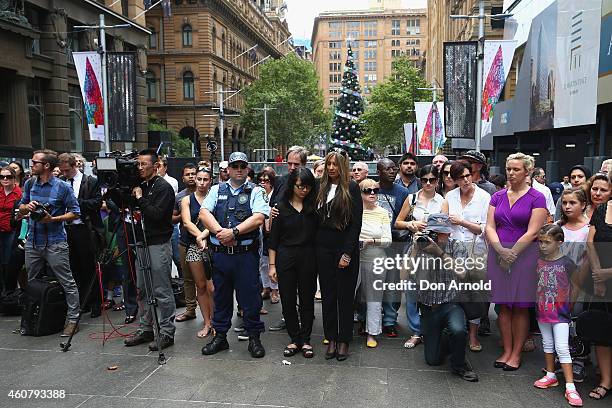 Siege victims Fiona Ma and Selina Win Pe amongst other persons paying their respect at a wreath laying ceremony after the funeral for Tori Johnson,...