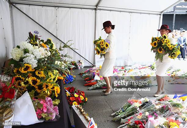 Funeral directors lay flowers at a wreath laying ceremony after the funeral for Tori Johnson, at Martin Place on December 23, 2014 in Sydney,...
