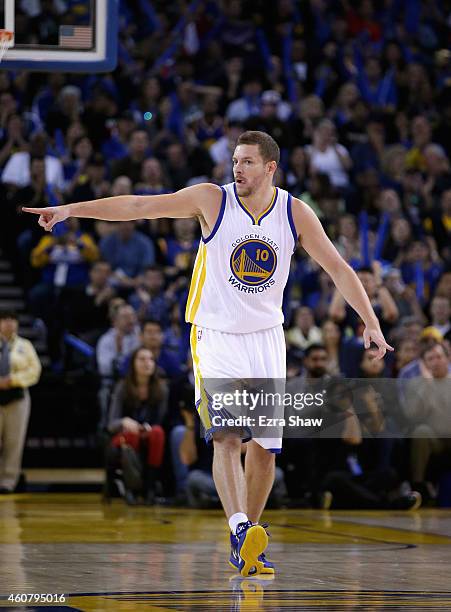 David Lee of the Golden State Warriors reacts after Andre Iguodala made a basket against the Sacramento Kings at ORACLE Arena on December 22, 2014 in...