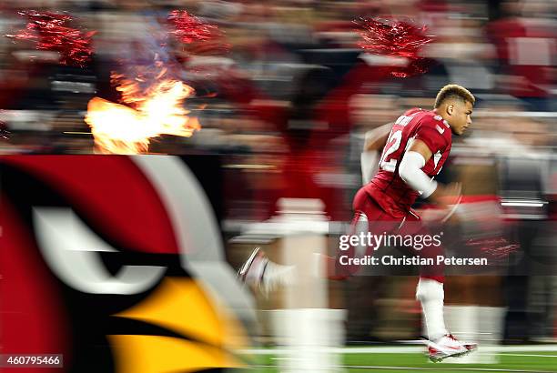 Free safety Tyrann Mathieu of the Arizona Cardinals runs out onto the field before the NFL game against the Seattle Seahawks at the University of...