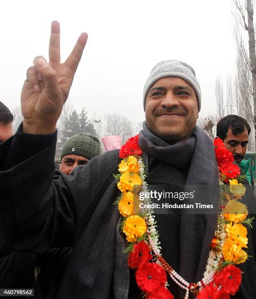 Peoples Democratic Party candidate from Sonawar constituency Mohammad Ashraf Mir gestures after winning against J & K incumbent Chief Minister Omar...