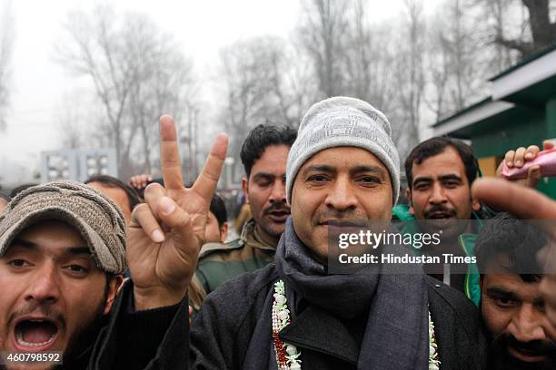 Peoples Democratic Party candidate from Sonawar constituency Mohammad Ashraf Mir gestures after winning against J & K incumbent Chief Minister Omar...