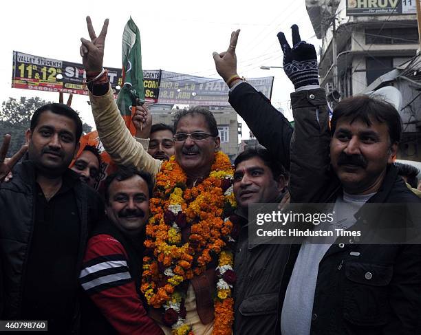 Candidate from Gandhi Nagar seat Kavinder Gupta gestures after his victory in Jammu And Kashmir assembly elections on December 23, 2014 in Jammu,...