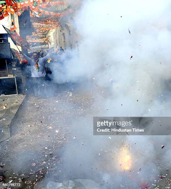 Bharatiya Janata Party supporters burst crackers to celebrate after their partys good performance in Jammu area in early election result trends...
