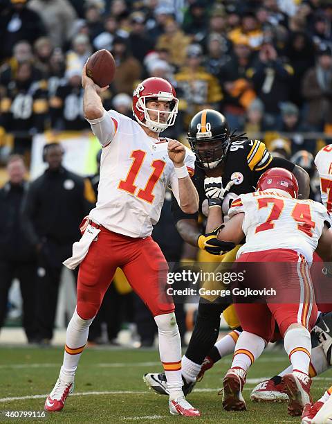 Quarterback Alex Smith of the Kansas City Chiefs passes as offensive lineman Jeff Linkenbach blocks defensive lineman Steve McLendon of the...