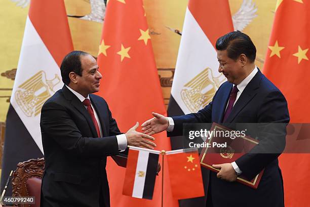 Egypt's President Abdel Fattah al-Sisi greets Chinese President Xi Jinping during a signing ceremony at the Great Hall of the People on December 23,...