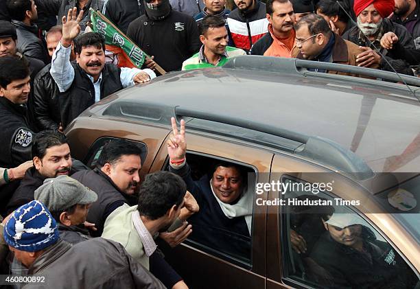 Candidate from Jammu East, Rajesh Gupta gestures after his win outside their party headquarters on December 23, 2014 in Jammu, India. PDP emerged as...