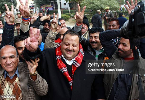 National Conference candidate from Nagrota, Davinder singh Rana gestures after his win outside their party headquarters on December 23, 2014 in...