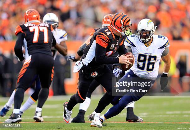 Quarterback Andy Dalton of the Cincinnati Bengals is pressured by outside linebacker Jarret Johnson of the San Diego Chargers during a Wild Card...