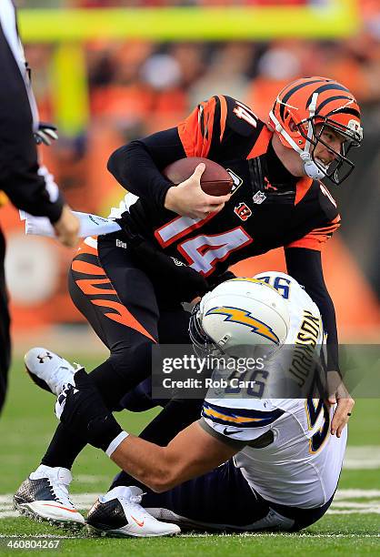 Quarterback Andy Dalton of the Cincinnati Bengals is sacked by outside linebacker Jarret Johnson of the San Diego Chargers during a Wild Card Playoff...