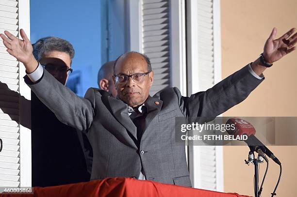 Tunisia's outgoing president Moncef Marzouki greets the audience as he adresses his supporters at his campaign headquarters on December 23, 2014 in...