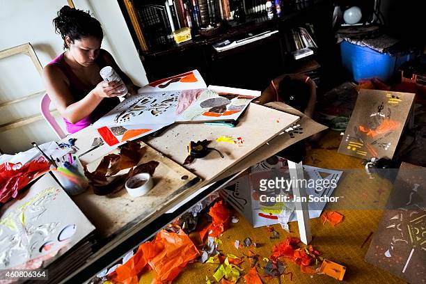 Woman works on her paper lanterns before the annual Festival of Candles and Lanterns on December 08, 2013 in Quimbaya, Colombia. A vibrant event,...
