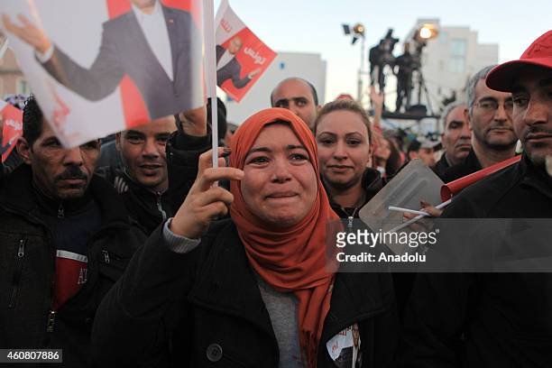 Supporters of Tunisia's outgoing president Moncef Marzouki gather outside his campaign headquarters to listen to his speech a day after his rival...