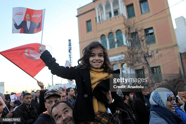 Supporters of Tunisia's outgoing president Moncef Marzouki gather outside his campaign headquarters to listen to his speech a day after his rival...