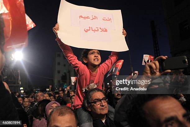 Supporters of Tunisia's outgoing president Moncef Marzouki gather outside his campaign headquarters to listen to his speech a day after his rival...