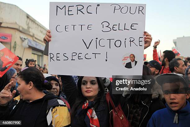 Supporters of Tunisia's outgoing president Moncef Marzouki gather outside his campaign headquarters to listen to his speech a day after his rival...