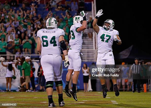 Devon Johnson of the Marshall Thundering Herd celebrates with Eric Frohnapfel after scoring a touchdown during the second quarter of the game against...