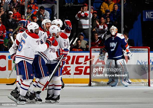 Andrei Markov of the Montreal Canadiens celebrates with teammates after scoring a second period goal against the New York Islanders at Nassau...