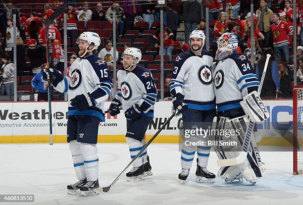 Matt Halischuk, Grant Clitsome, Jay Harrison and goalie Michael Hutchinson of the Winnipeg Jets celebrate after defeating the Chicago Blackhawks 5-1...