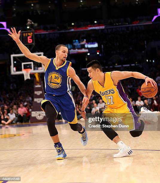 Jeremy Lin of the Los Angeles Lakers srives against Stephen Curry of the Golden State Warriors at Staples Center on December 23, 2014 in Los Angeles,...