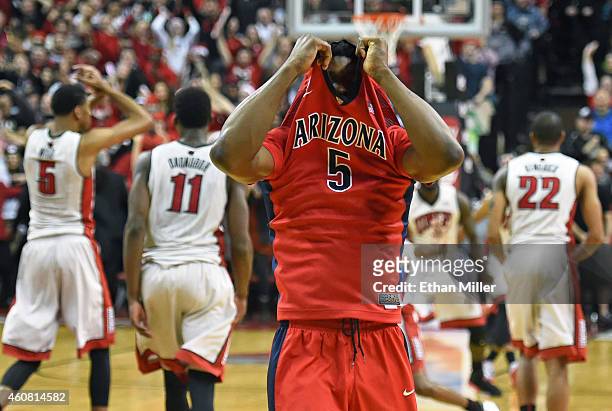 Stanley Johnson of the Arizona Wildcats pulls his jersey up and walks toward his bench after turning the ball over in the final seconds of the team's...
