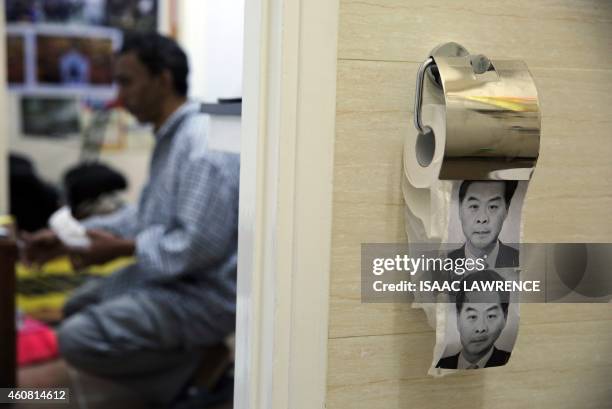 This photo taken on December 23, 2014 shows novelty toilet paper with the image of Hong Kong's Chief Executive Leung Chun-ying in a flat turned into...